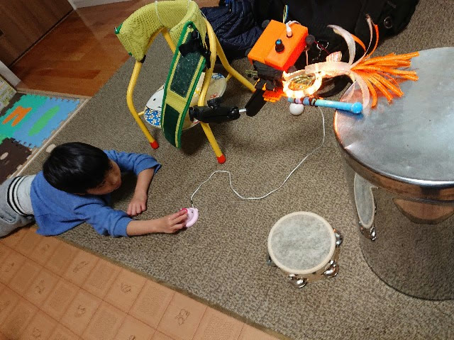 打楽器ハンド（プロトタイプ）でタンバリンを叩いて遊ぶ息子